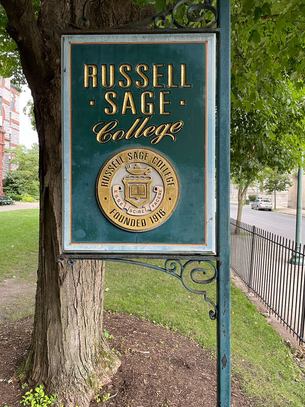 Sign for Russell Sage College, Troy, New York, featuring the college seal.