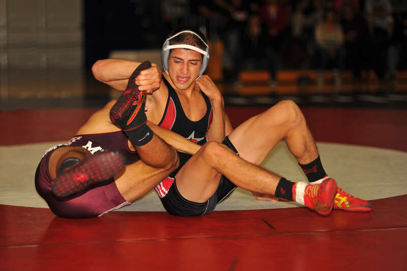 Junior Lule grabs Steven Melara's sole as Melara tries to pull him back down to the mat.
141# Steven (Stevo) Melara  (Mt San Antonio College) DEC Ascary (Jr, Junior) Lule (Palomar College) DEC 5-3

BIV_8954a_cr
