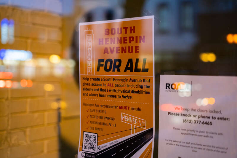 A sign hanging in a storefront with their views on the Hennepin Avenue reconstruction.