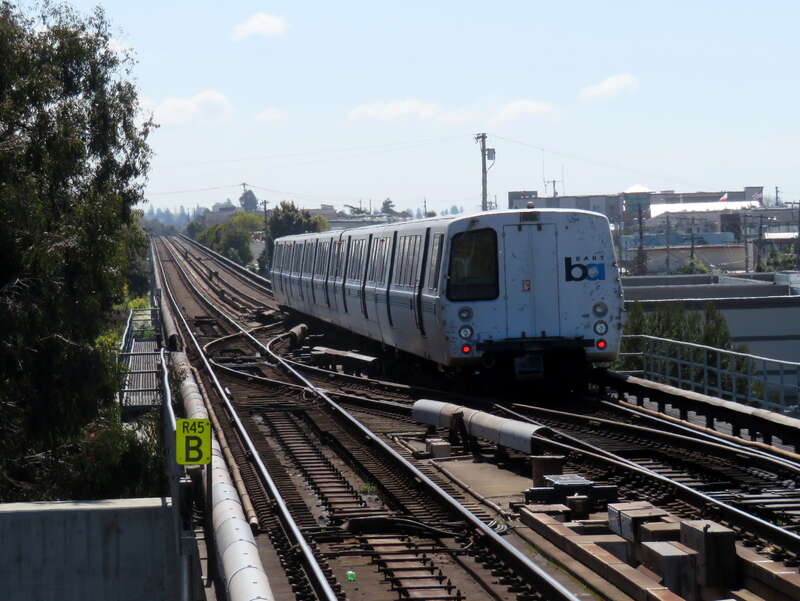 A Millbrae-bound train passing through R45 interlocking just south of El Cerrito del Norte station in March 2019