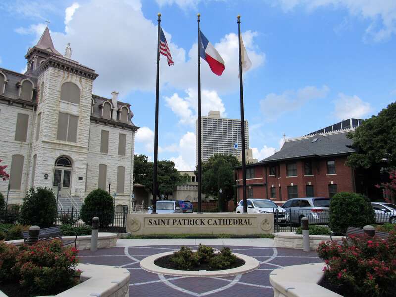 The sign at St. Patrick Cathedral in downtown Fort Worth, Texas.  The former St. Ignatius Academy building is on the left and the parish rectory is on the right.