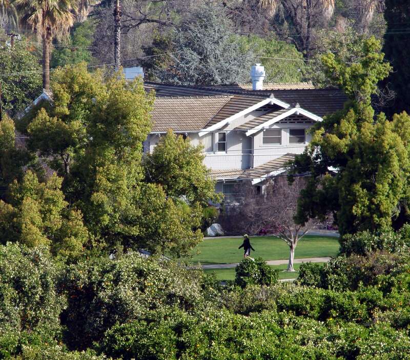 (1 in a multiple picture set)
I was up in Prospect Park in Redlands, CA shooting some grove pictures when I saw this person strolling in the early morning sun in front of one of our great homes on Highland Ave.