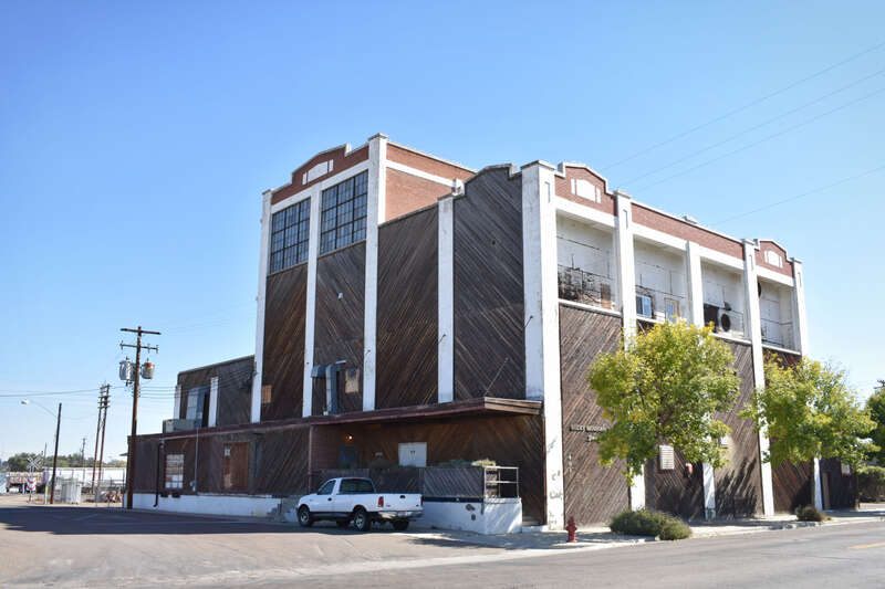 The Swift &amp; Company Building (1926), a 4-story brick building covered in wood.