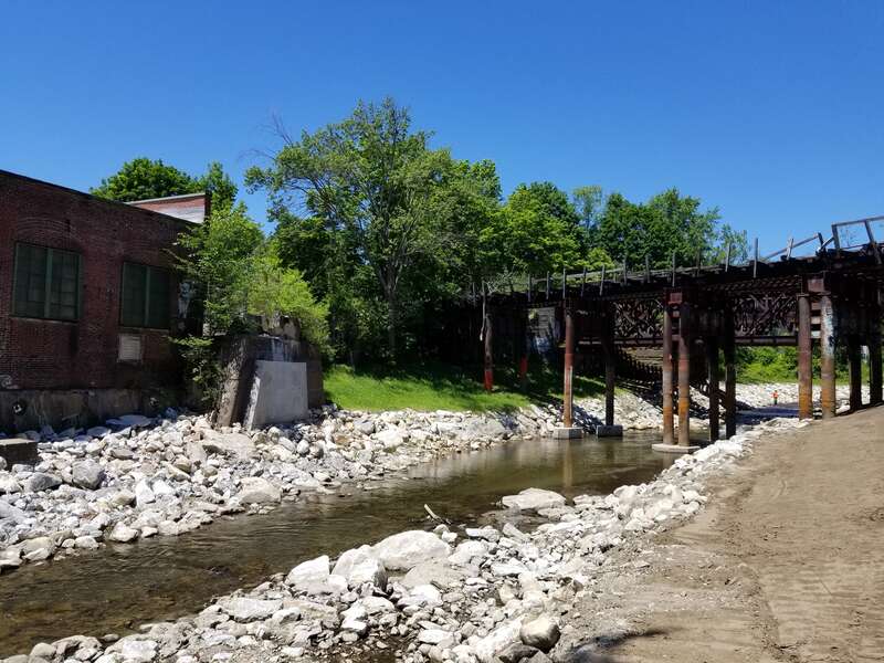 "Tel-Electric site post-dam removal June 2020. The West Branch of the Housatonic River flows freely past the historic Tel-Electric factory building and a small portion of the former dam."