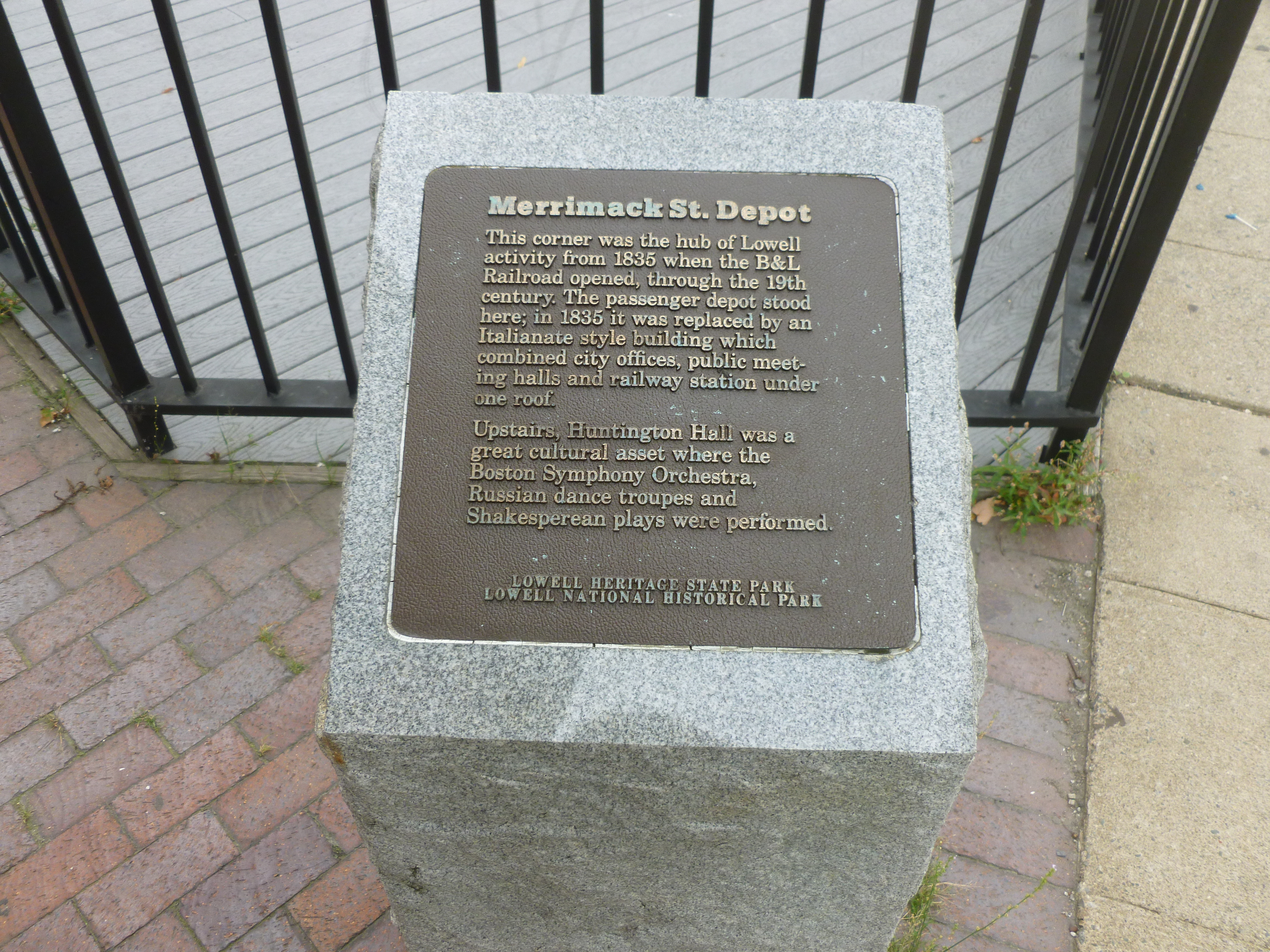 'Merrimack Street Depot' historical plaque, located at the southeast corner of the intersection of Merrimack Street and Dutton Street in Lowell, Massachusetts.