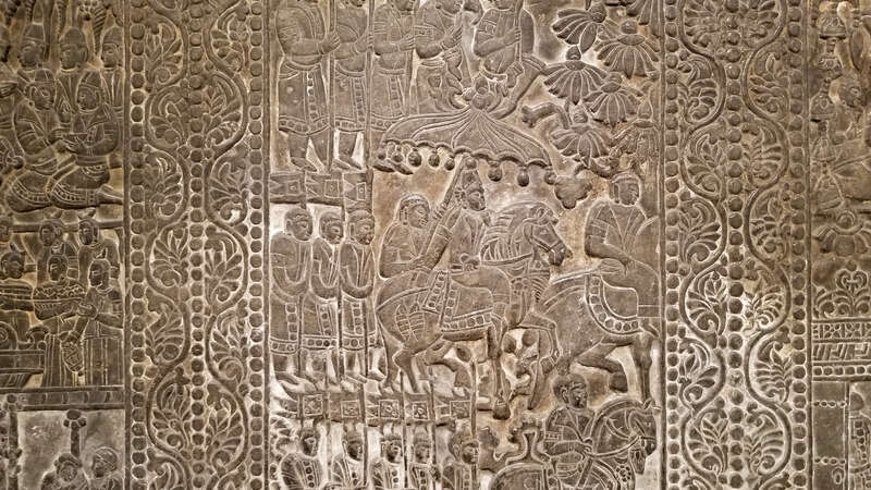 Back panel of a funerary bed showing the deceased drinking from a bull headed rhyton and entertained by fancers and musicians under a grape arbor. Sogdian and Zorastrian imagery. China, Northern Qi, 550 AD - 577 AD, From the Museum of Fine Arts,
