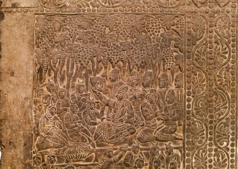 Back panel of a funerary bed showing the deceased drinking from a bull headed rhyton and entertained by fancers and musicians under a grape arbor. Sogdian and Zorastrian imagery. China, Northern Qi, 550 AD - 577 AD, From the Museum of Fine Arts,