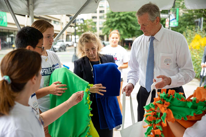 "Governor Charlie Baker and First Lady Lauren Baker join state and local officials to make care packages for members of the military with the Massachusetts Military Heroes Fund and Project 351 in Boston on Sept. 11, 2022."