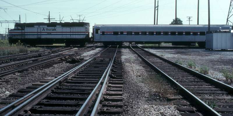 The northbound Hoosier State, running on the ex-Pennsylvania Railroad Bernice Cutoff, crosses the Indiana Harbor Belt Railroad at CP Calumet Park in September 1982. F40PH locomotive #304 is pulling ex-Union Pacific coach #4609 (formerly #4565 and