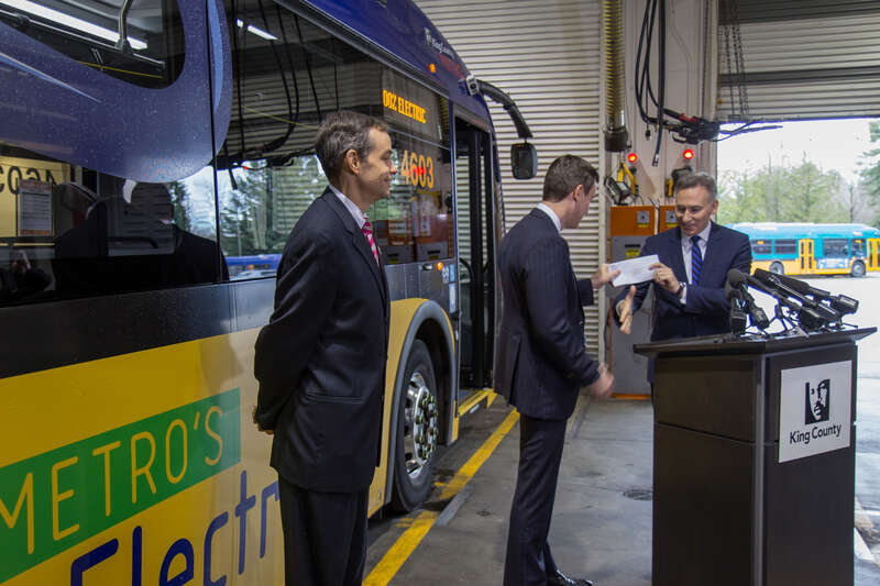 King County Executive Dow Constantine hands Proterra CEO Ryan Popple <a href="https://www.documentcloud.org/documents/3259987-Proterra-Letter-0-10-17-Signed.html" rel="nofollow">a letter for up to 73 buses</a>.  King Country Metro General