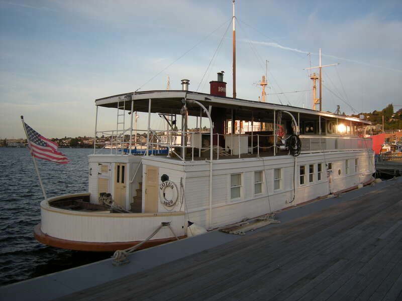 MV Lotus (with dinghy stashed), normally moored in Olympia, Washington, visiting the Historic Ships Wharf, Seattle, Washington. The 1909 boat is listed on the National Register of Historic Places.