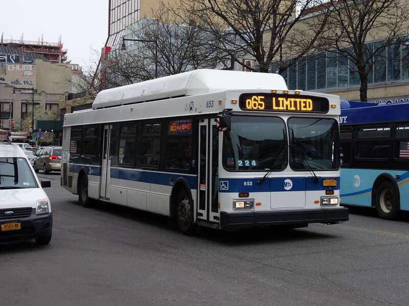 A Jamaica LIRR-bound Q65 Limited bus traveling south on Main Street between Northern Boulevard and 37th Avenue in Downtown Flushing, Queens.