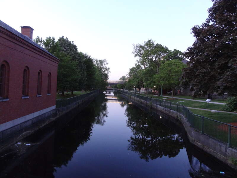 Merrimack Canal viewed from the bridge at Middlesex Street in Lowell, Massachusetts.  

Moody Street Feeder Gatehouse is visible at left.
Lucy Larcom Park is visible at right.