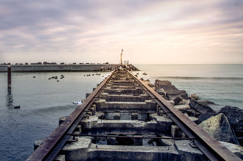 chilly november morning at the old pier and breakwater for the church street power boat ramp in evanston, illinois, near northwestern university.  no powerboats but plenty of ducks and gulls were making use of the facilities.