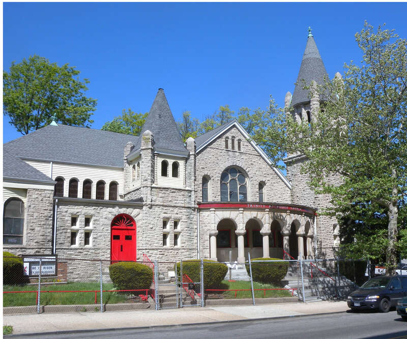 Looking northeast across Clinton Avenue from near Osborne Terrace, at Trinity United Methodist Church on a sunny midday.