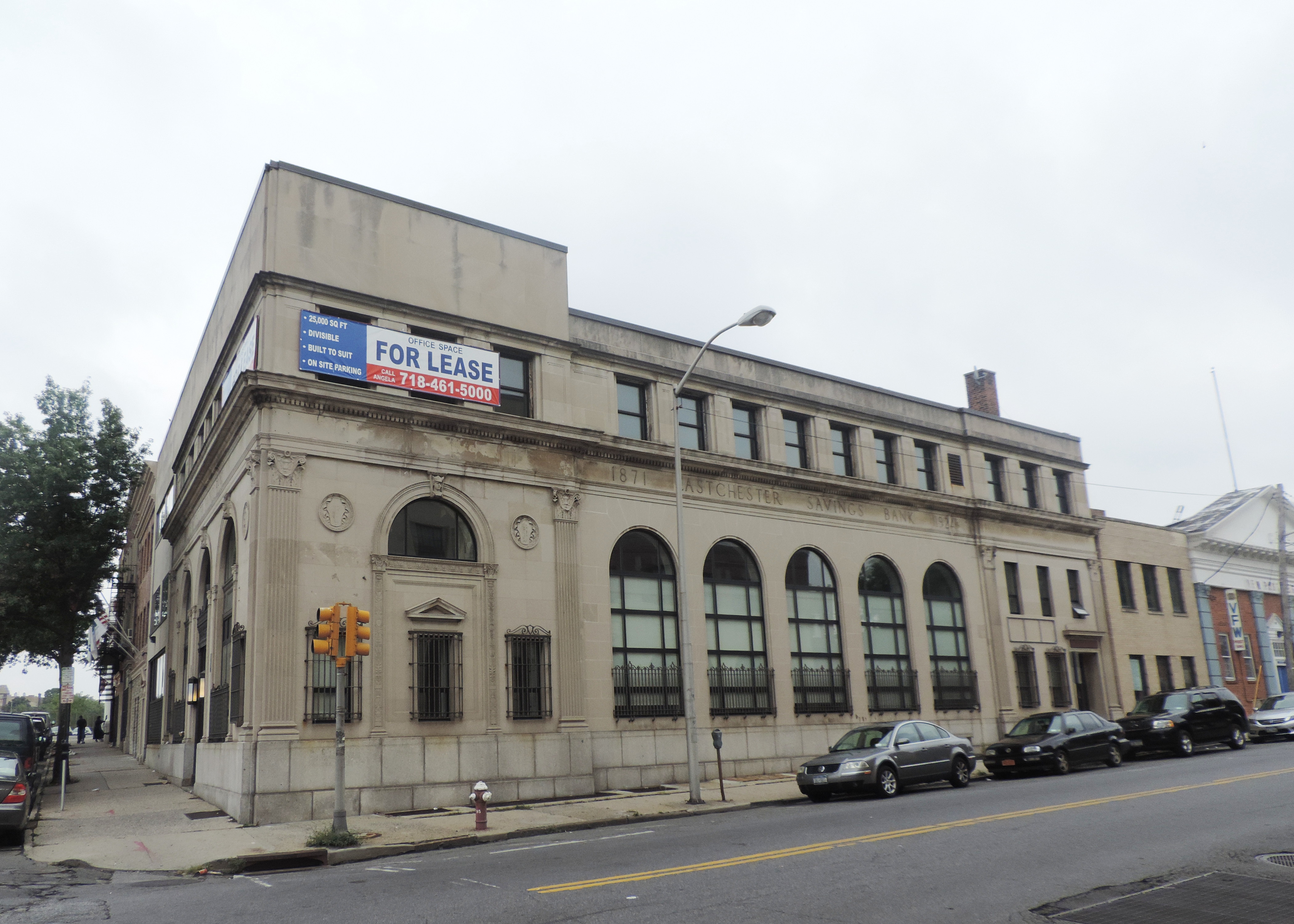 Looking southwest at former bank on a cloudy midday.