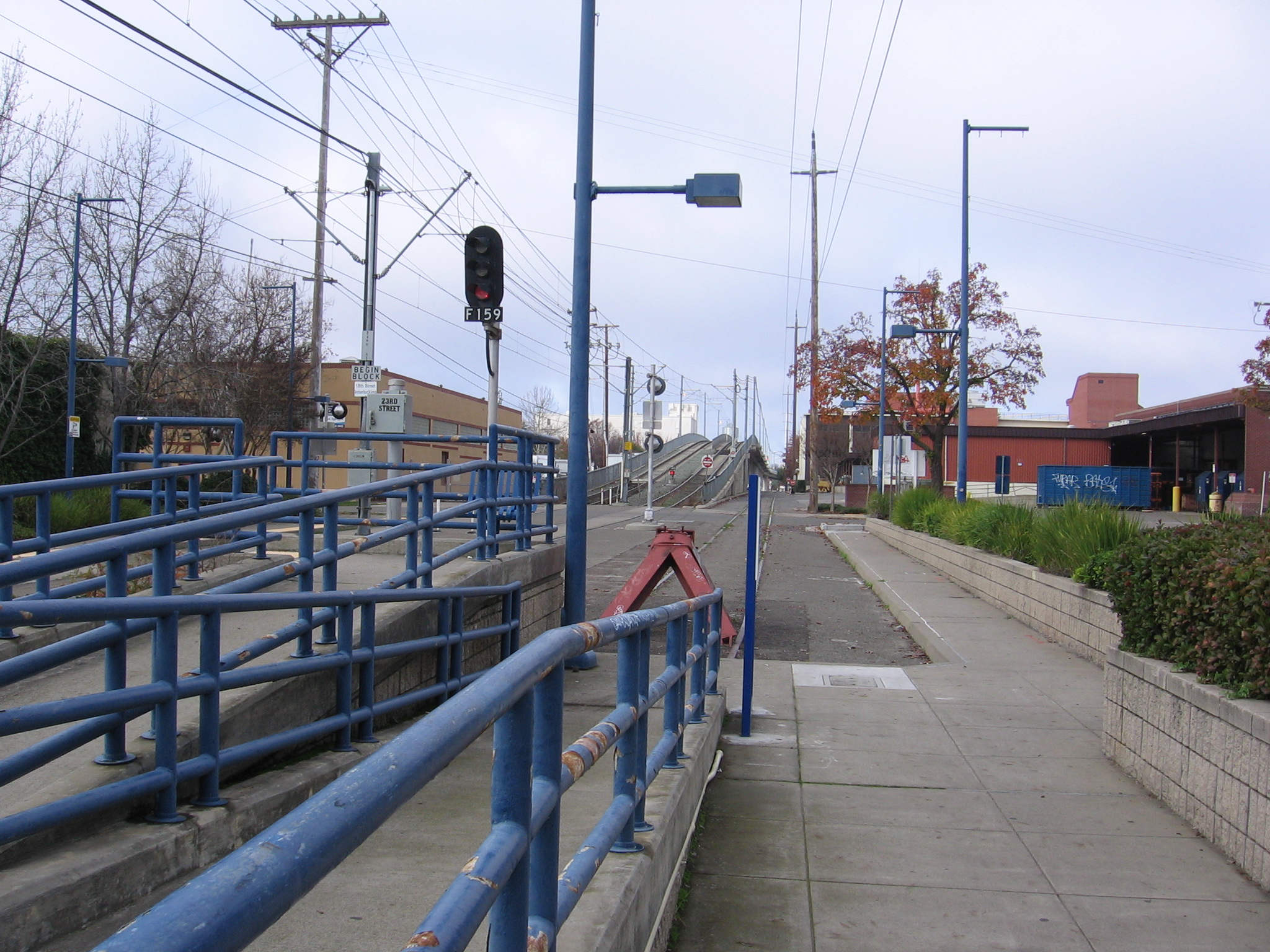 The 23rd Street (Sacramento RT) light rail station in Sacramento, California, USA.  Looking west at the light rail overpass of the Union Pacific line, the print plant of The Sacramento Bee lies to the right.