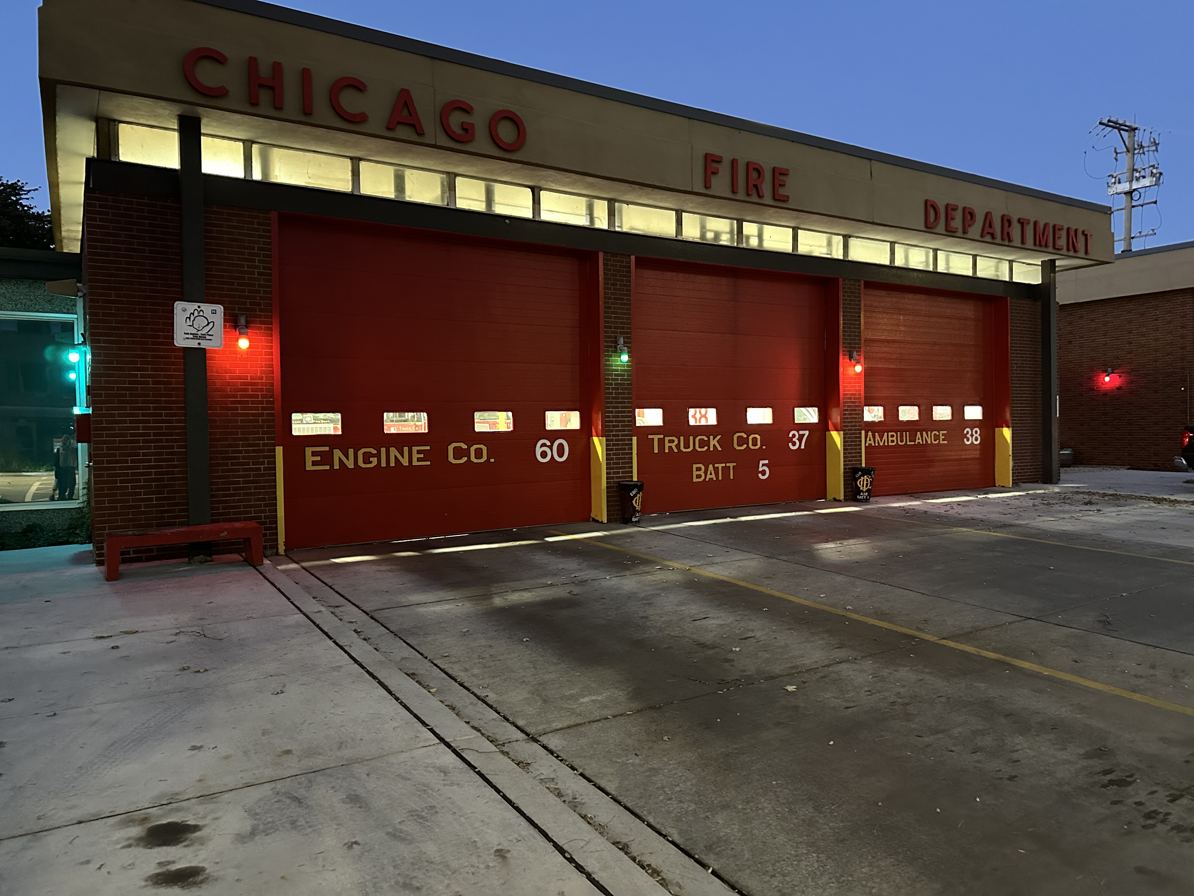 A blue hour view of Engine Company 60 firehouse, including Truck Company 37 and Ambulance 38 as part of Battalion 5, located on E 55 St in the Hyde Park neighborhood of Chicago.