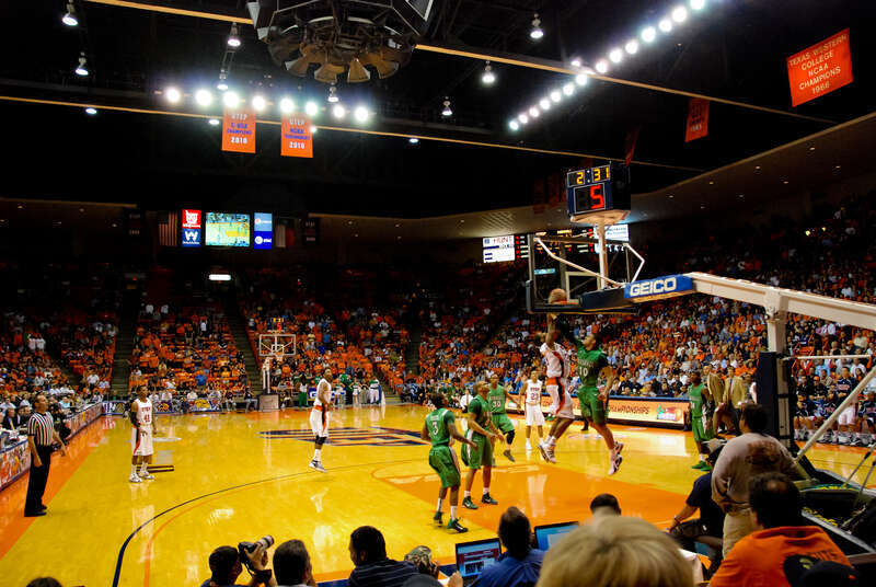 The interior of the Don Haskins Center on the campus of the University of Texas at El Paso (UTEP). Jeremy Williams of UTEP (#34 in white) dunks over Dago Pena of Marshall (#10 in green) during a Conference USA Tournament game on March 10, 2011. Note