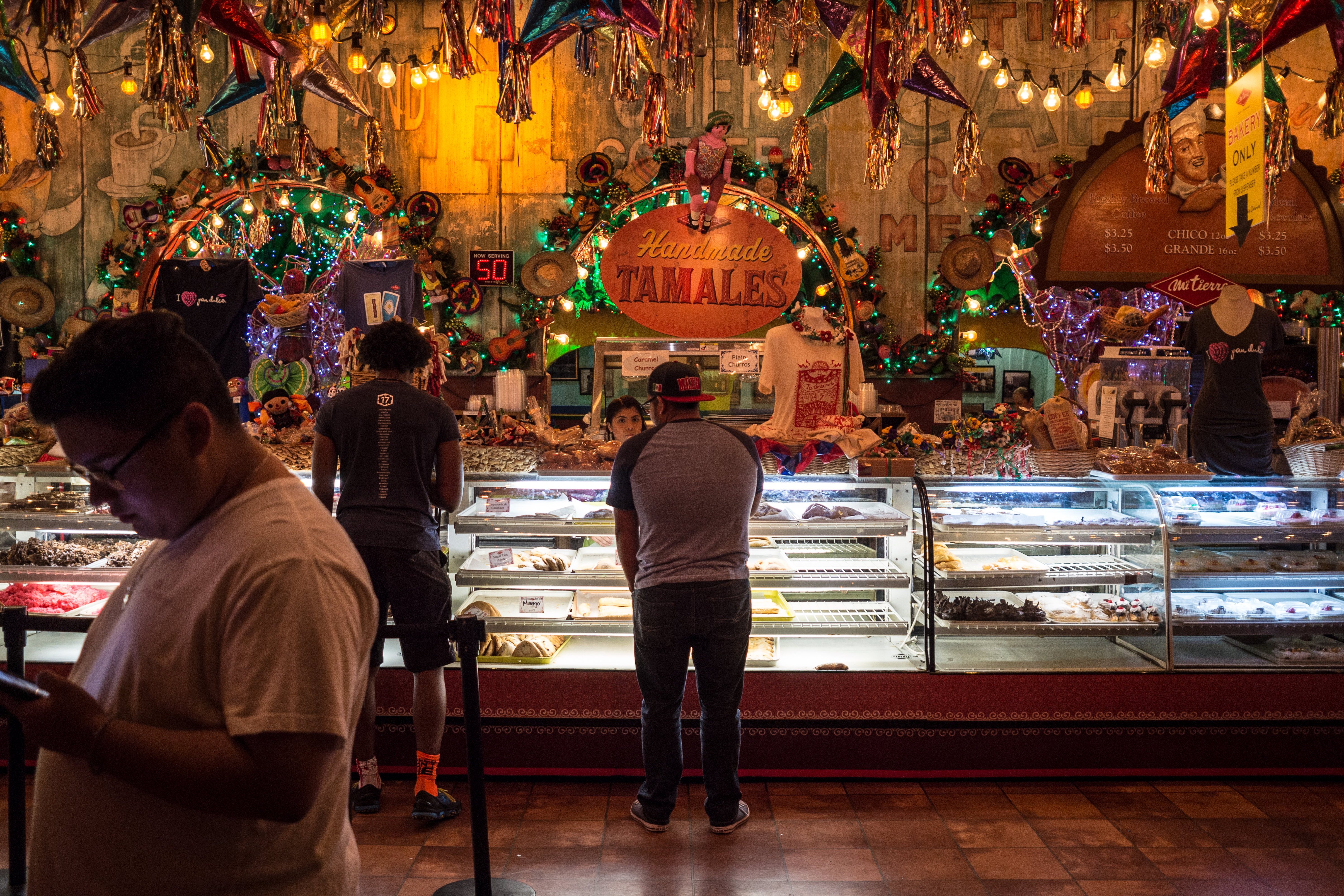 A couple of people look at the bakery counter at the famous Mi Tierra Cafe.