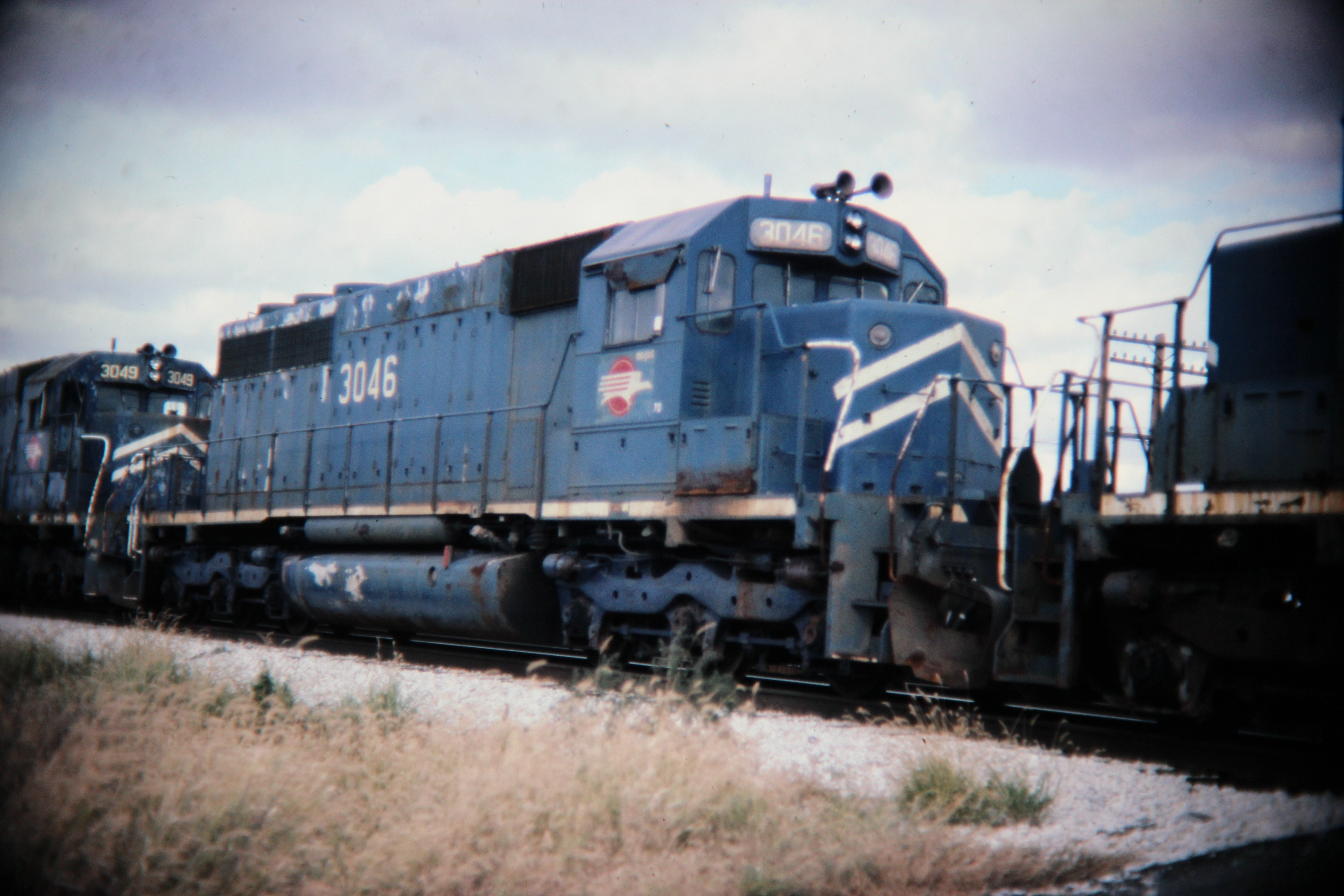 Mopac SD40 dead in tow, Savoy, IL; Western U.S. railroads, 1986; digital copy of slide. Complete indexed photo collection at WorldHistoryPics.com.