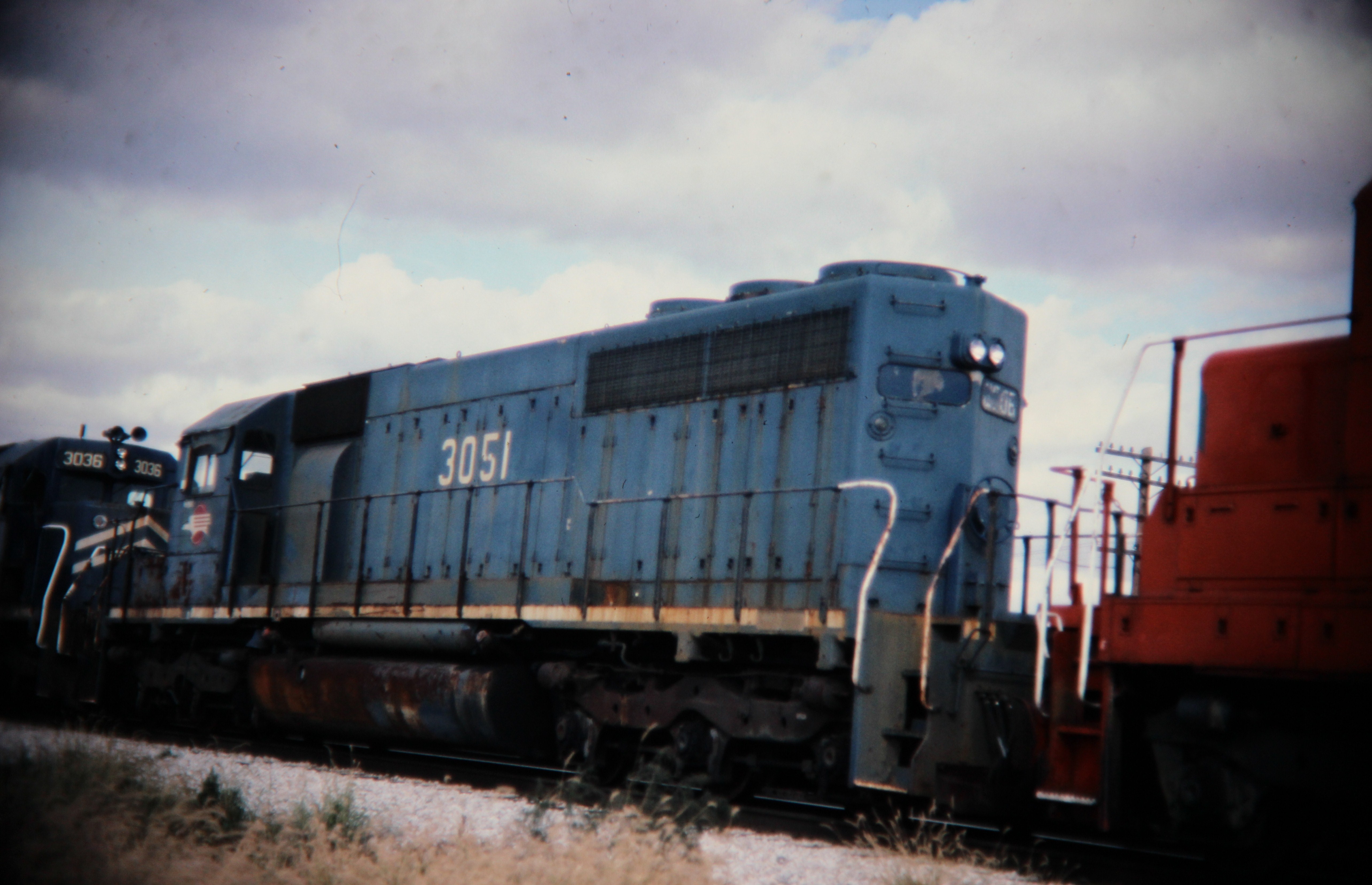 Mopac SD40 dead in tow, Savoy, IL; Western U.S. railroads, 1986; digital copy of slide. Complete indexed photo collection at WorldHistoryPics.com.