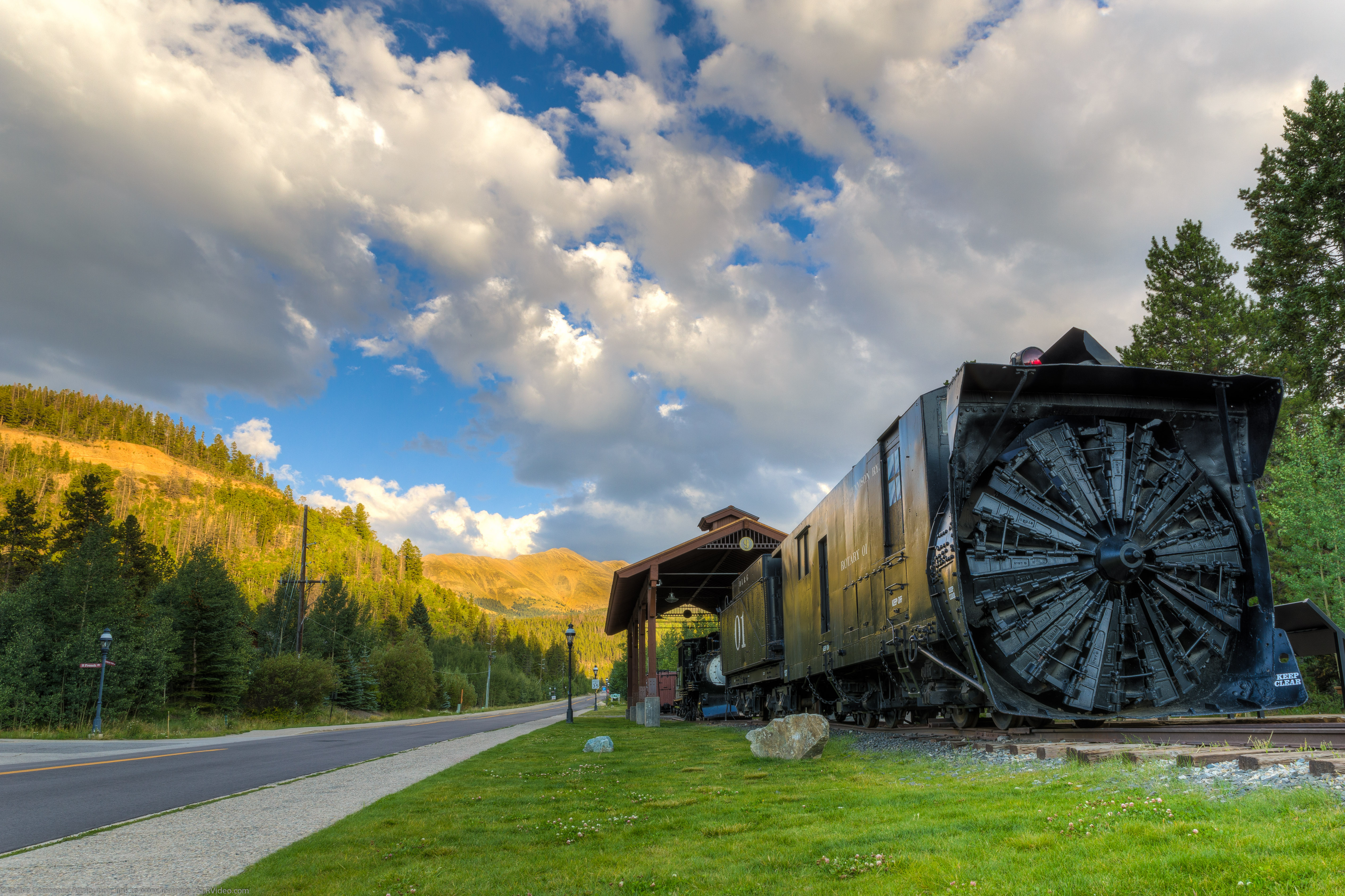 This is my 2nd attempt shooting this train, the first time (2 years ago)  I blew out the clouds but this time I did a much wider bracketed shot.
HDR using photomatix.
I like the warm colors on the mountains behind the train.

Feel free to use this