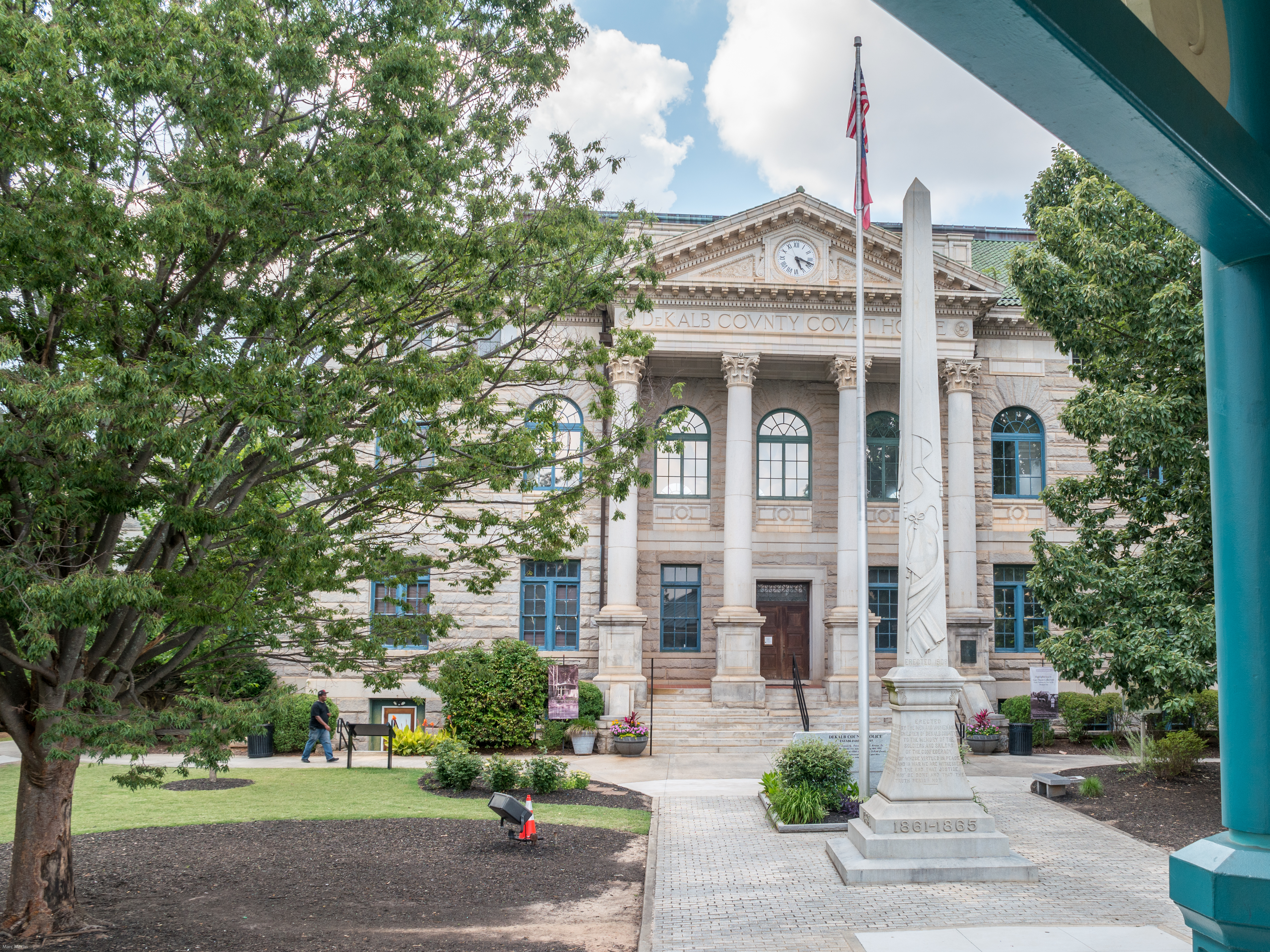 South facade of the Historic DeKalb County Courthouse viewed from the gazebo in Decatur Square. The DeKalb County Confederate obelisk can be seen centered vertically in the frame to the right.
