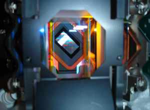 This is a close up look at the Light Engine from a digital projector.  You can see the DMD (Digital Micromirror Device) in the back of the prism,